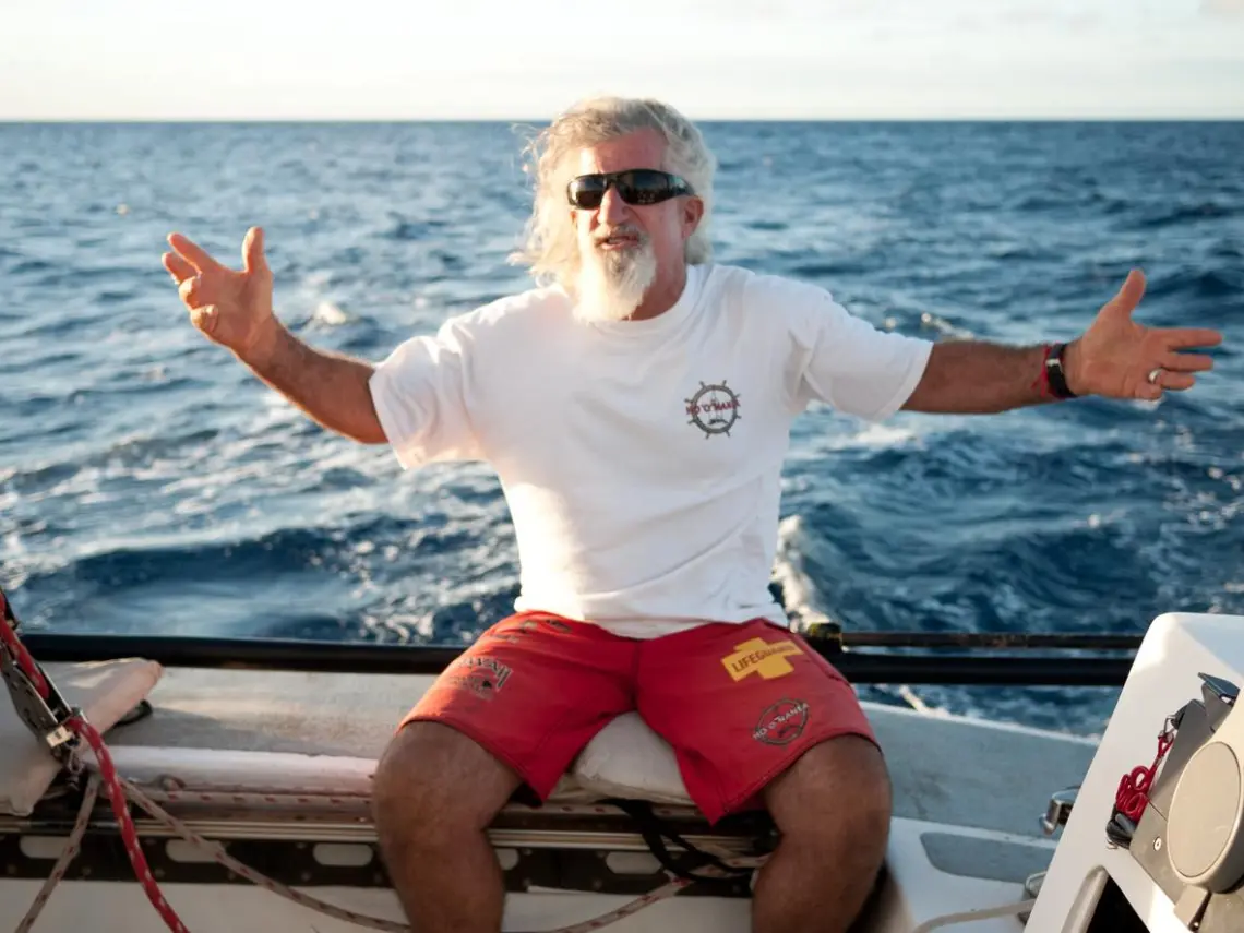 a man sitting in a boat on a body of water